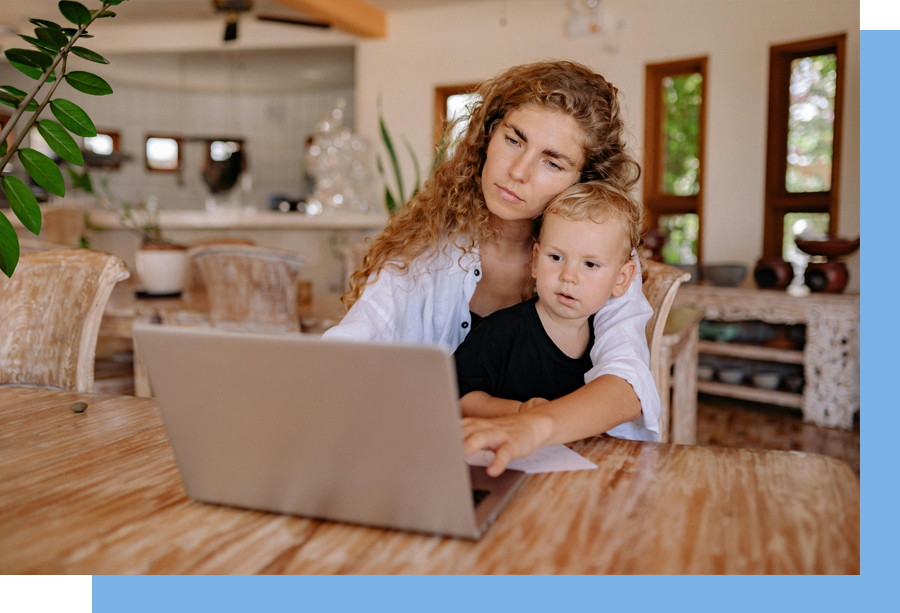 A woman and child looking at a laptop.